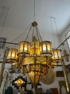 a chandelier hanging from the ceiling in a room with many lights on it