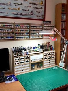 a workbench with lots of crafting supplies and tools on the desk in front of it