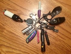 there are many different types of keys on this wooden table, including pens and scissors