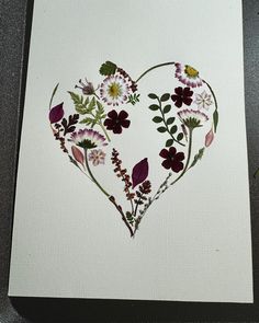 a card with flowers in the shape of a heart