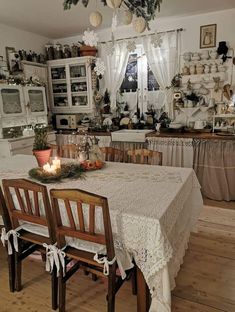 a dining room table and chairs in front of a window