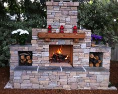 an outdoor fireplace with logs in it