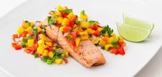 salmon with mango salsa on a white plate