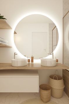 a bathroom with two sinks and a round mirror