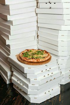 a pizza sitting on top of stacks of boxes