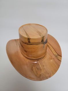 Beautiful wood-turned hat made from Ambrosia Maple signed and numbered by the artist, Brian Butler. Make a fashion statement in this unique hat! Measurements: Inside circumference: 22 inches Bill: 17.25" x 15" Height: 6.5" Weight: 3 lbs. ﻿Hatband and stand available for purchase separately. Wooden Hats, Lathe Woodworking Projects, Best Wood Lathe, Unique Hats, Wood Lathe, Paper Sculpture, Hat Band, Cowboy Hat, Hat Making