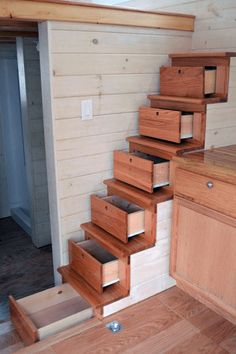 the stairs are made out of wood and have drawers on each side