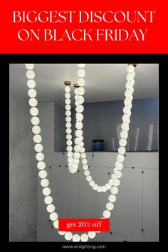 an advertisement for a black friday sale with white beads hanging from the ceiling and in front of