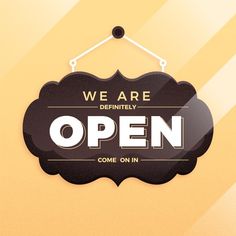 we are definitely open sign hanging on the wall in front of a yellow and orange background