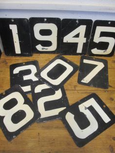 four old black and white numbers are laying on the floor