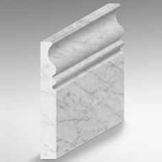 an image of a white marble column with the corner cut out to show it's design