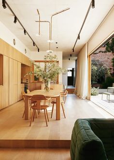 a dining room table and chairs in front of sliding glass doors