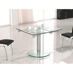 a glass table and two chairs in a room with white tiles on the floor,