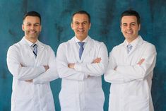 three men in white lab coats are posing for a photo with their arms crossed and looking at the camera