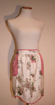 a white dress with pink trim and flowers on it