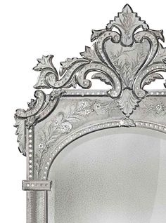 an ornate silver mirror on a white background