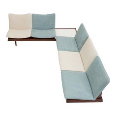 two couches with blue and white cushions on top of each other in front of a white background