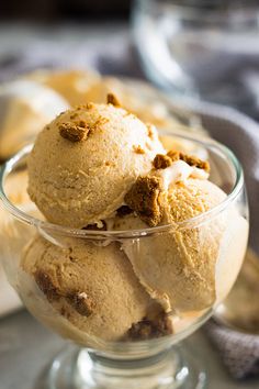 three scoops of ice cream in a glass bowl