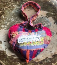 a patchwork heart that says you are love