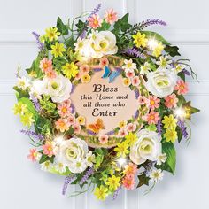 a wreath with flowers and butterflies on it that says,'bless this home and all those who enter