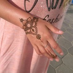 a woman's hand with hennap on her left arm and the word love written