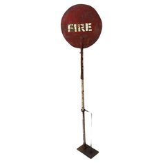 an old fashioned fire extinguisher on a stand with the word fire painted on it