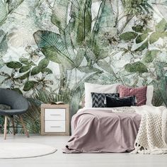 a bedroom with a large wall mural featuring tropical plants and leaves on the walls, along with a bed