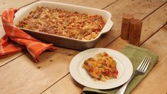 a casserole dish on a plate with a fork and napkin next to it