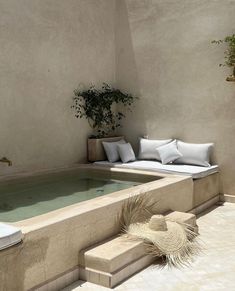 an outdoor jacuzzi is shown with white pillows