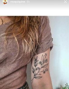 a woman's arm with a flower tattoo on the left side of her arm