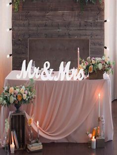 the table is set up with candles and flowers on it for an elegant wedding reception