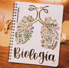 a spiral notebook with the word biologia written on it and an illustration of a tree