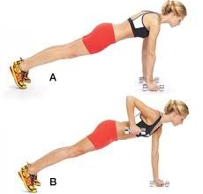 a woman doing a plank exercise with dumbs on one side and another in the other