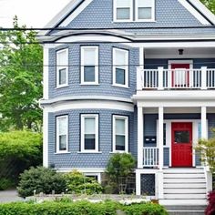 a blue house with white trim and red door