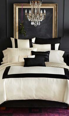 black and white bedding with chandelier in the background