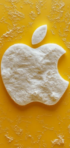 an apple logo made out of flour on a yellow background