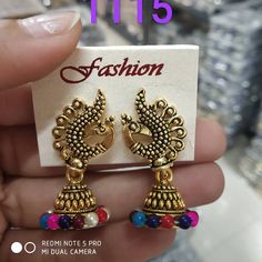 0 Likes, 0 Comments - Khushi Creation (@khushicreationrajkot) on Instagram: “Golden jhumki with multi coloured ❤  DM for bulk order 👍  #jhumki #jhumkilove #jhumkies #jhumkilove…” Earring Pins, Jhumki Earrings, Bulk Order, Red Heart