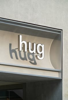 a sign that reads hug on the side of a building