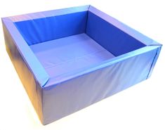 an empty blue box sitting on top of a white floor with no people around it