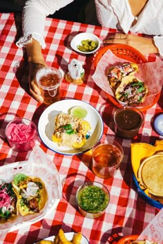 people sitting at a table with food and drinks