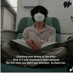 a man sitting in an office chair with a mask on his face while reading a book