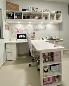 an office with white desks and shelves filled with supplies