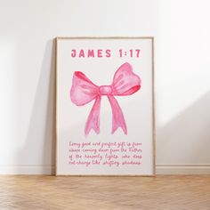 a pink poster with the words james 11 17 and a bow on it in front of a white wall