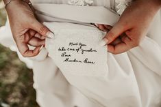 a person holding a piece of cloth with writing on it