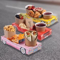 an assortment of food items are placed on a toy car in the middle of the road