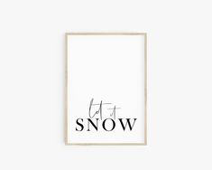 a black and white print with the words let it snow in cursive font