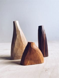 three wooden vases sitting on top of a table