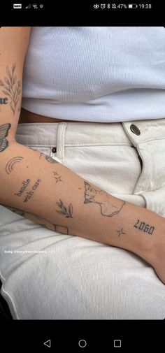 a woman's arm with tattoos on it