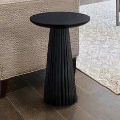 a black table sitting on top of a wooden floor