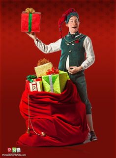 a man in an elf costume is holding presents on top of a pile of presents